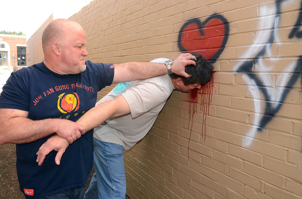 Sifu Davis demonstrating smashing attacker's face against brick wall